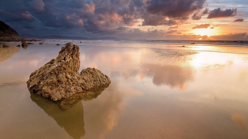 Rock on Wet Beach — Orange, Dramatic