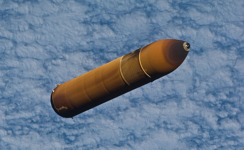 rocket in space above clouds