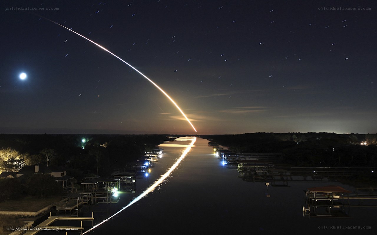 Rocket launch over canal at night