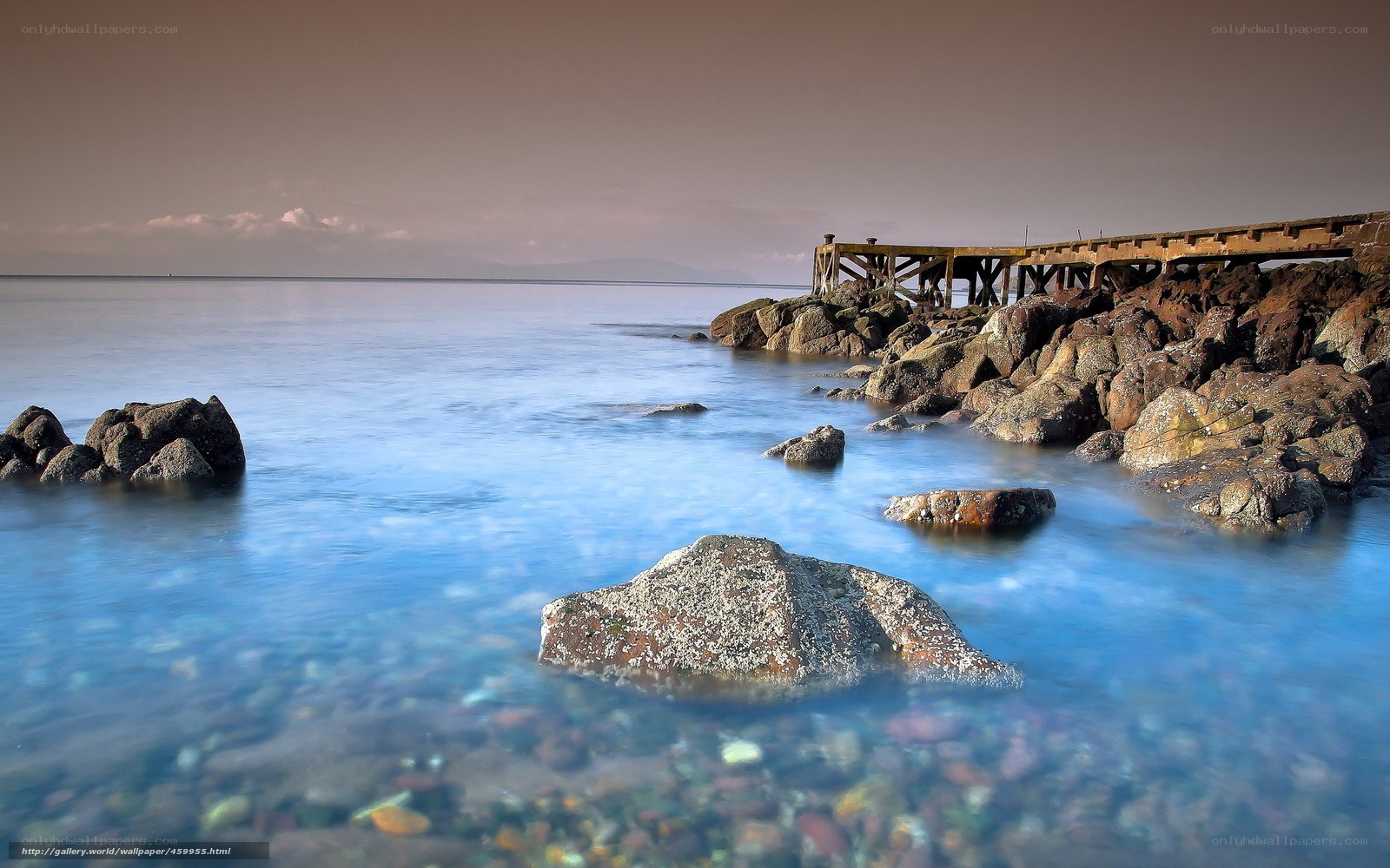 Rocks and old pier at sunset