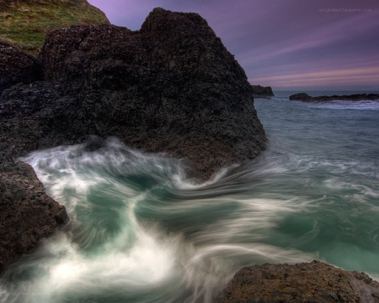 Rocks and waves at dusk