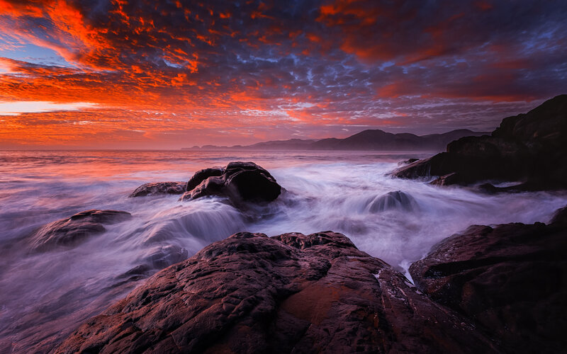 Rocks at Ocean Shoreline — Red, Dramatic
