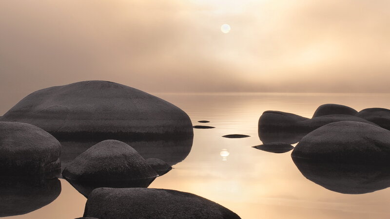 rocks at sunrise on calm water
