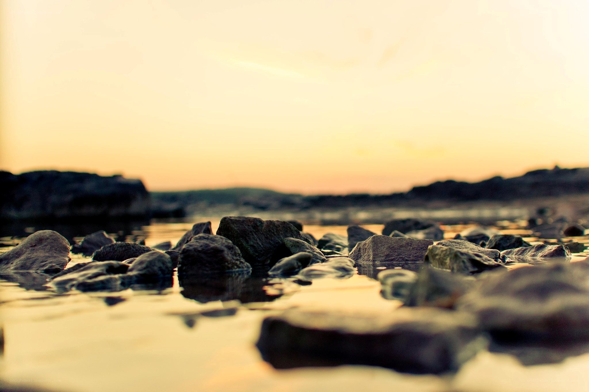 rocks at sunset by water