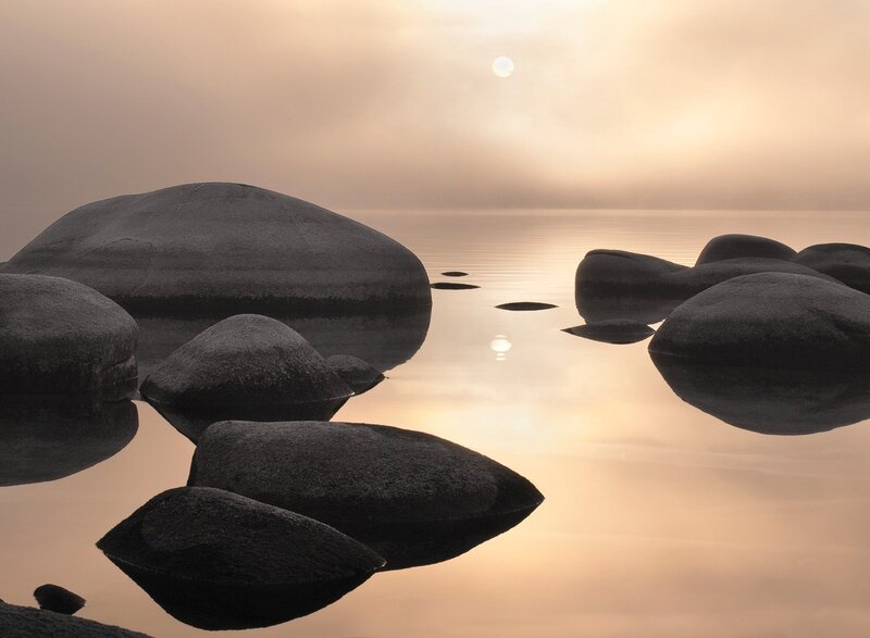 rocks in calm water at sunrise