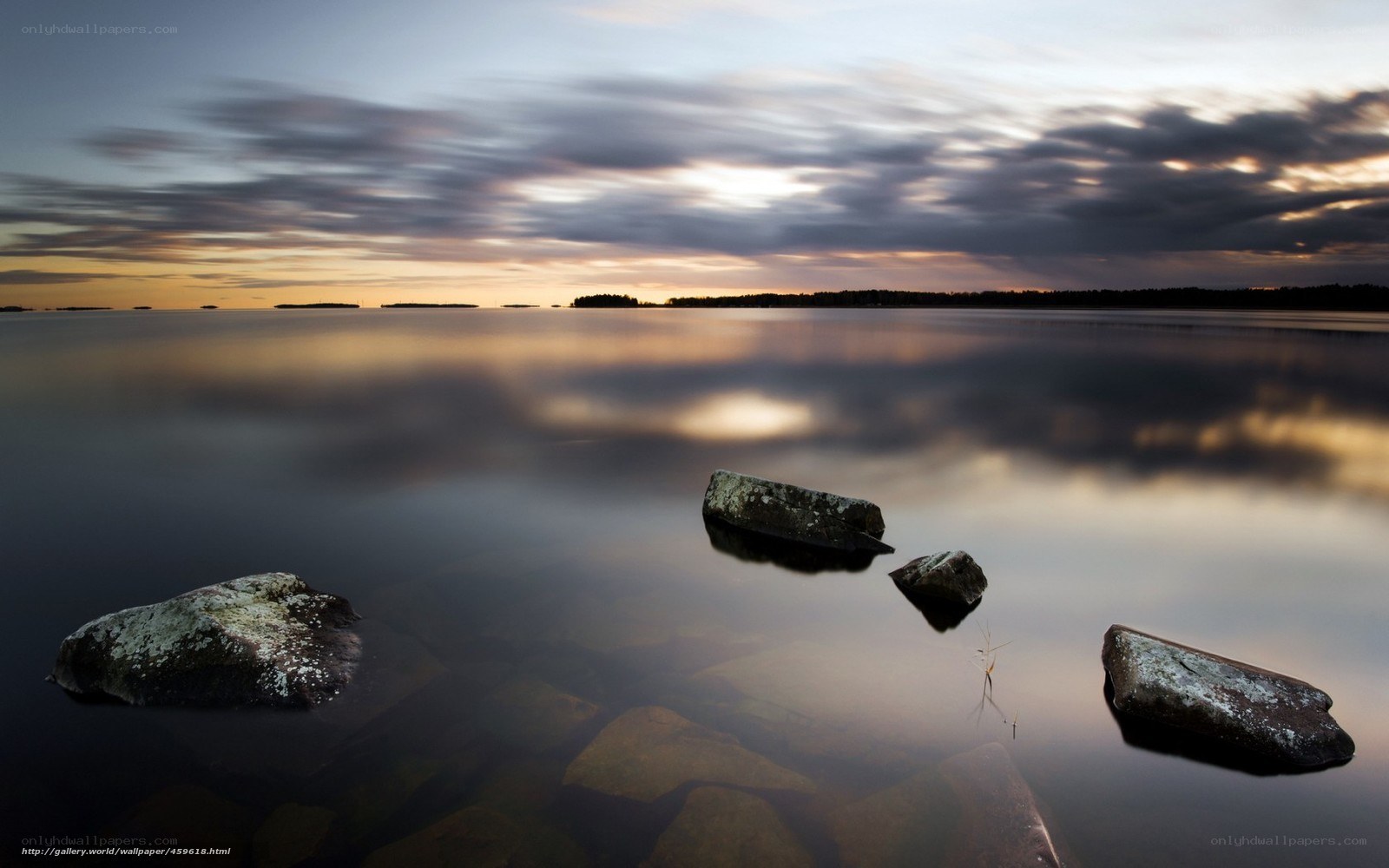 Rocks in calm water at sunset