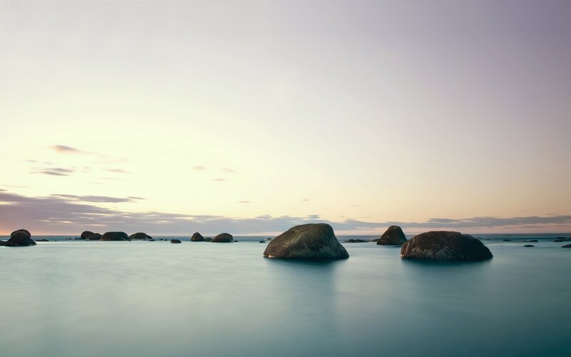 Rocks in Calm Water — Blue, Serene, Sunset, Photograph, Sea, Sky, Gray