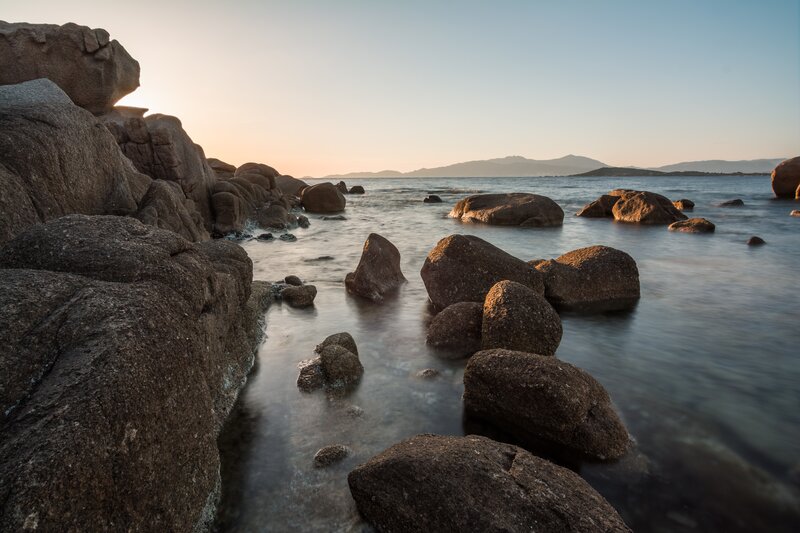 Rocks in Calm Water — Brown