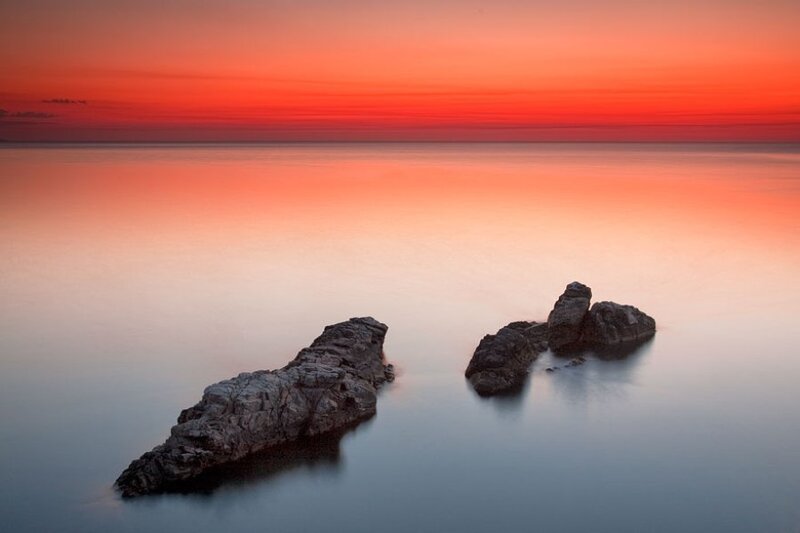 Rocks in Calm Water — Red
