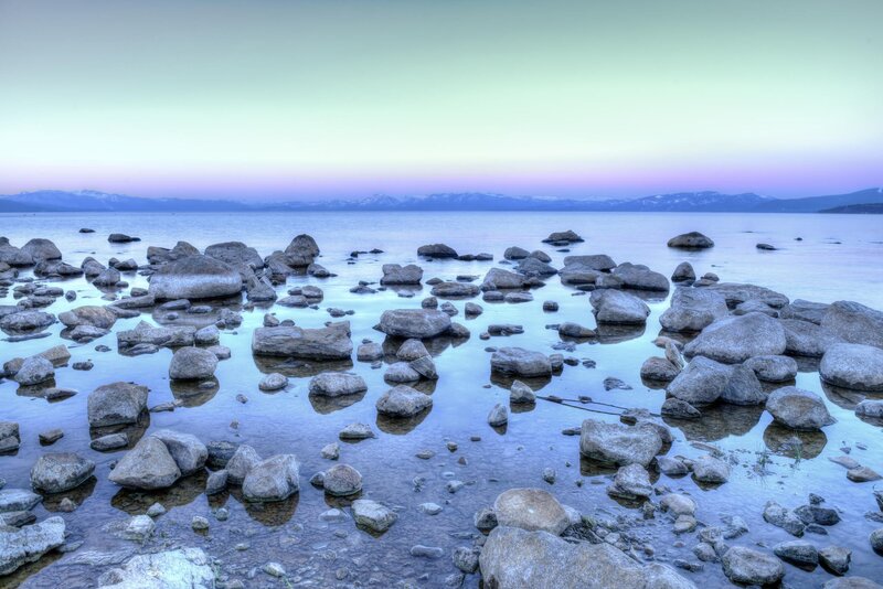 Rocks in Lake Water — Blue, Serene, Sunset, Photograph, Mountains, Sky