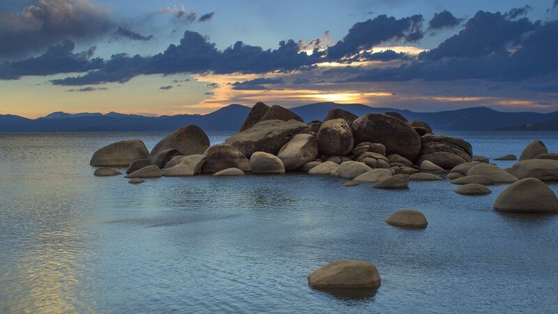 Rocks in Lake Water — Blue, Serene, Sunset, Photograph, Mountains