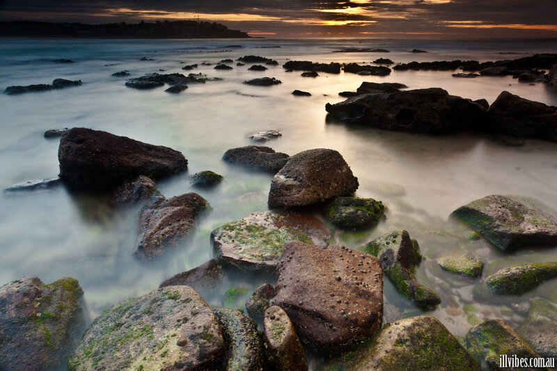 Rocks in Ocean at Sunset — Brown