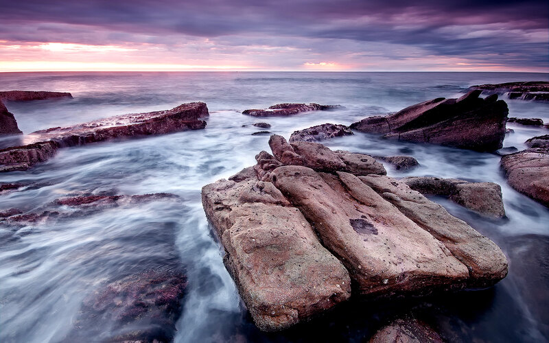 Rocks in Ocean at Sunset