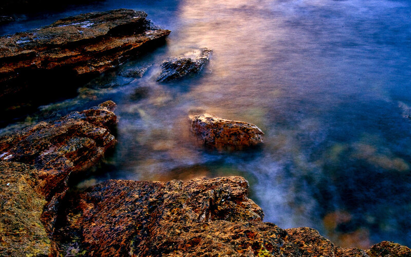 Rocks in the ocean at sunset