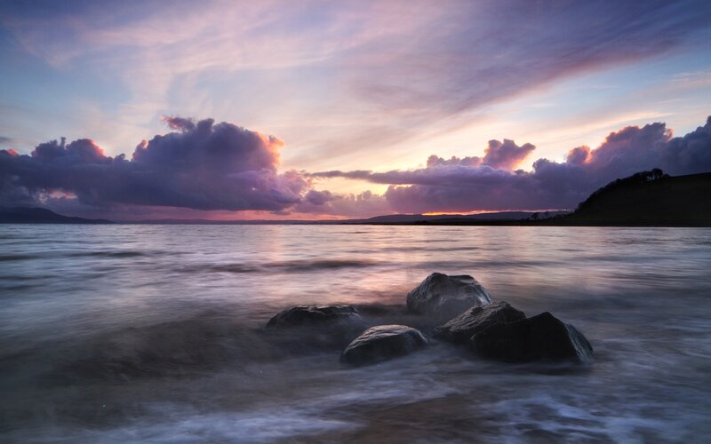 Rocks in Water at Sunset — Purple