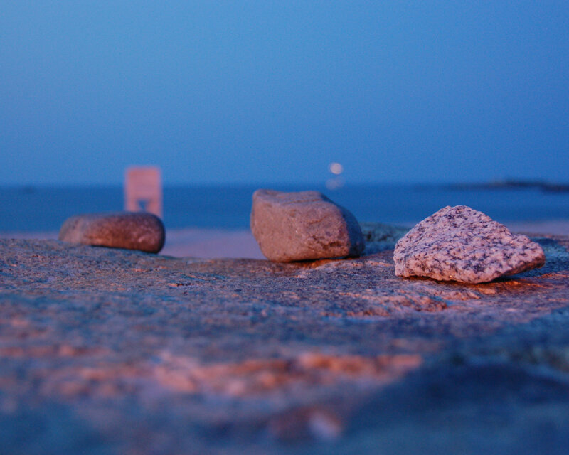 rocks on a beach at dusk