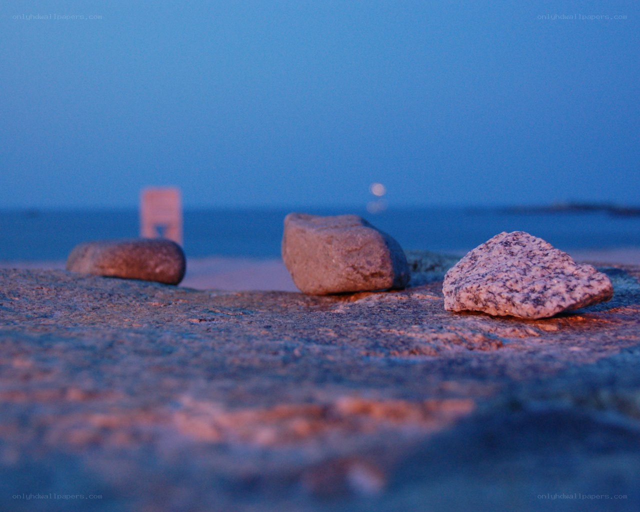 rocks on a beach at dusk