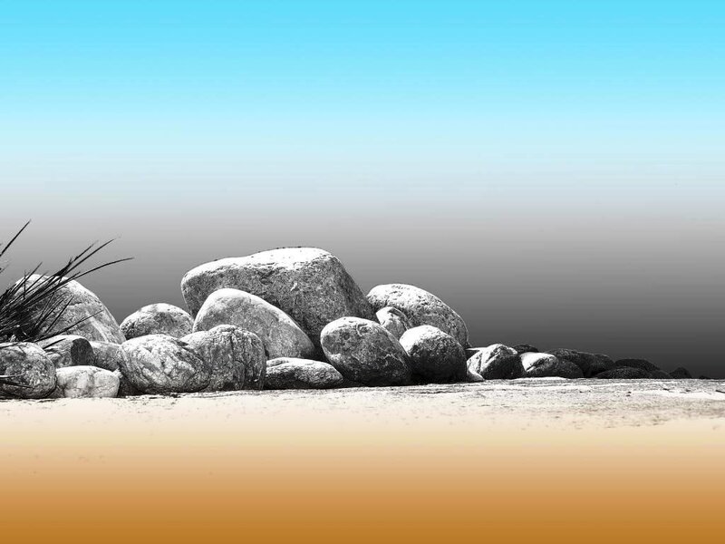 rocks on a beach at sunset
