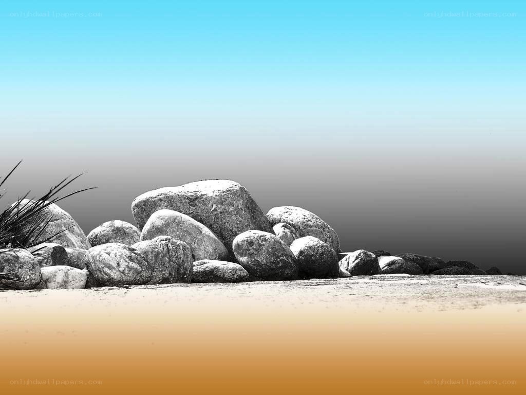 rocks on a beach at sunset