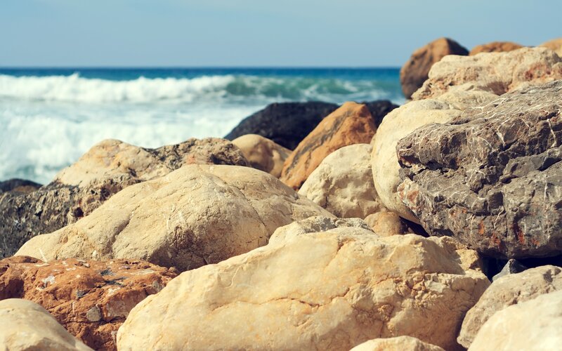 rocks on a beach with ocean