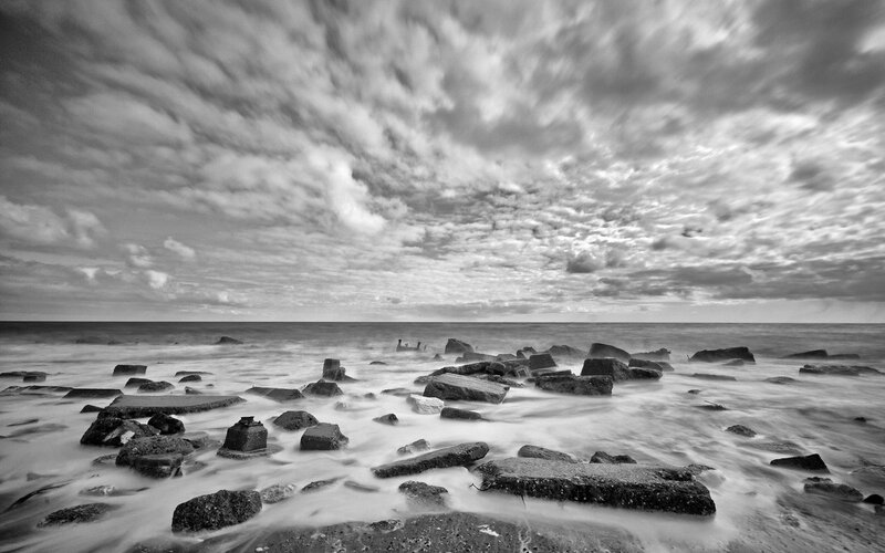 Rocks on Beach at Sea — Black