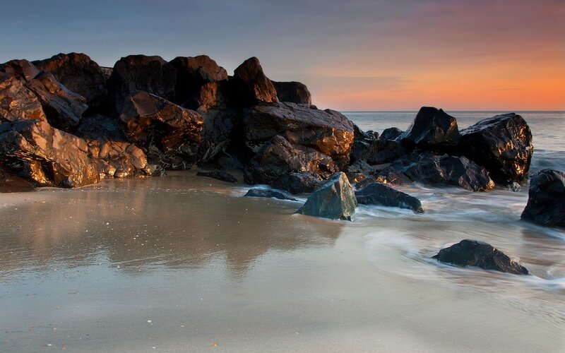 Rocks on Beach at Sunset — Orange, Serene, Photograph, Ocean, Sky, Sand, Blue, Black
