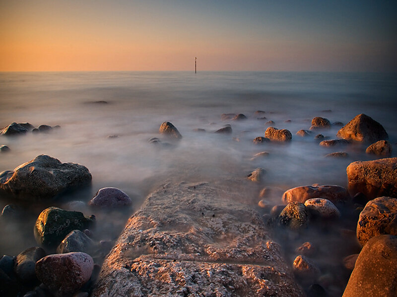 Rocks on Beach at Sunset — Orange, Serene