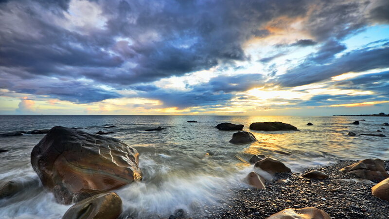 Rocks on Pebble Beach — Blue, Dramatic, Sunset