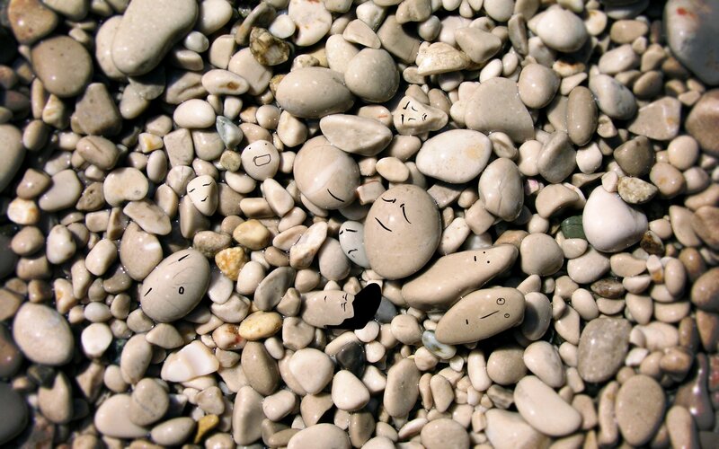 rocks with drawn faces