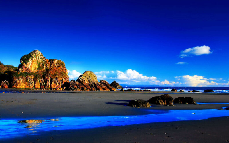 Rocky Beach at Ocean — Blue, Serene, Afternoon, Photograph, Rocks, Sand, Clouds
