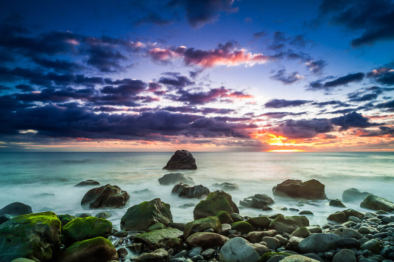 Rocky Beach at Sunset — Blue, Dramatic, Photograph, Rocks, Ocean, Clouds, Sun