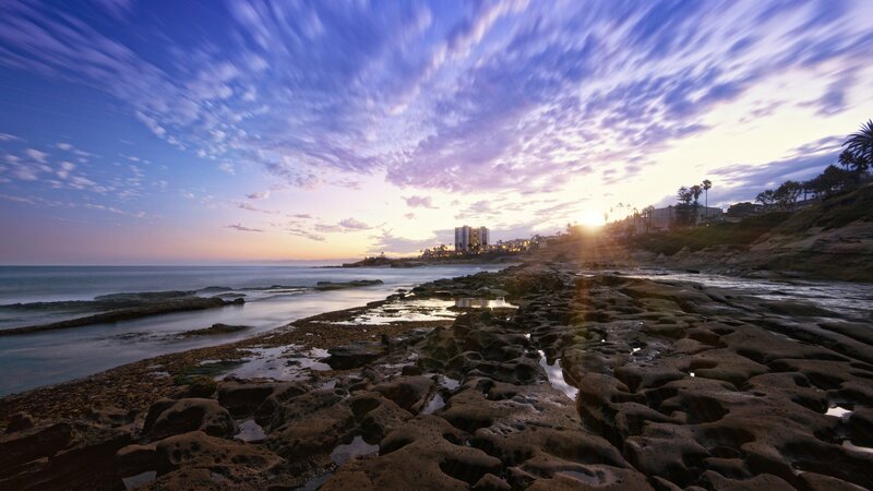 Rocky Beach at Sunset — Blue, Serene, Photograph, Ocean, Buildings