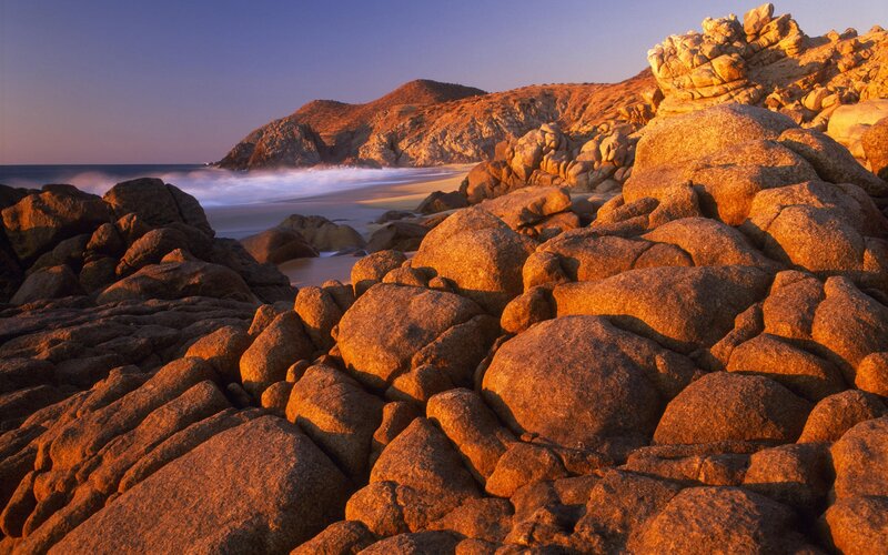 Rocky Beach at Sunset — Orange, Serene, Photograph, Ocean, Waves, Hills, Brown