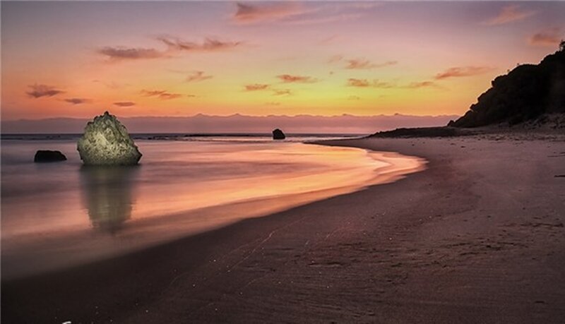 Rocky Beach at Sunset — Orange, Serene, Photograph, Rocks, Ocean, Mountains