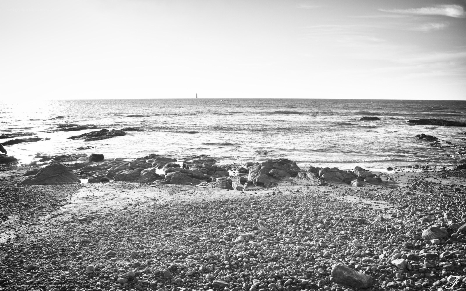 Rocky beach with distant lighthouse
