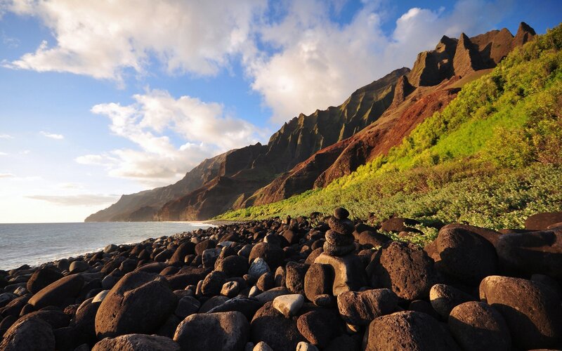 Rocky beach with green cliffs
