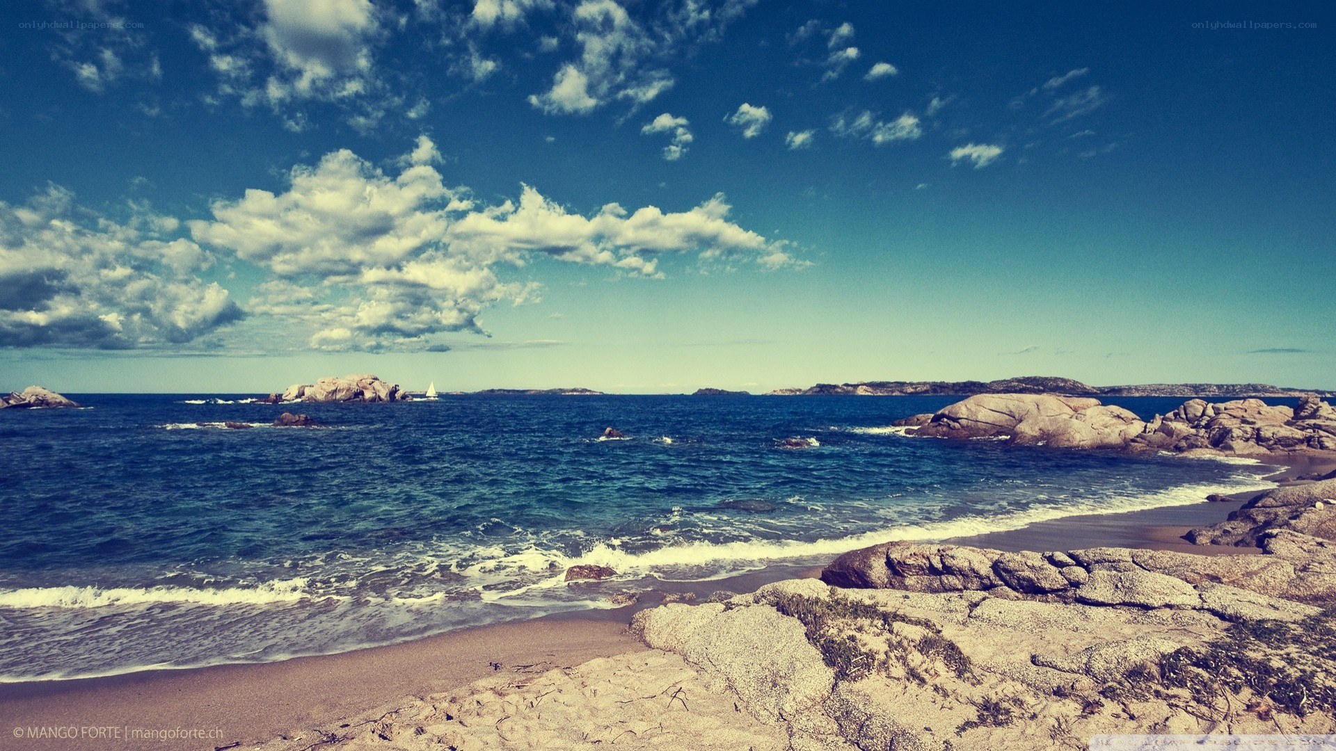 Rocky beach with sailboat