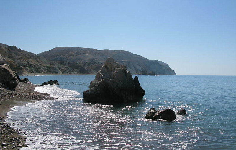 rocky beach with sea and hills