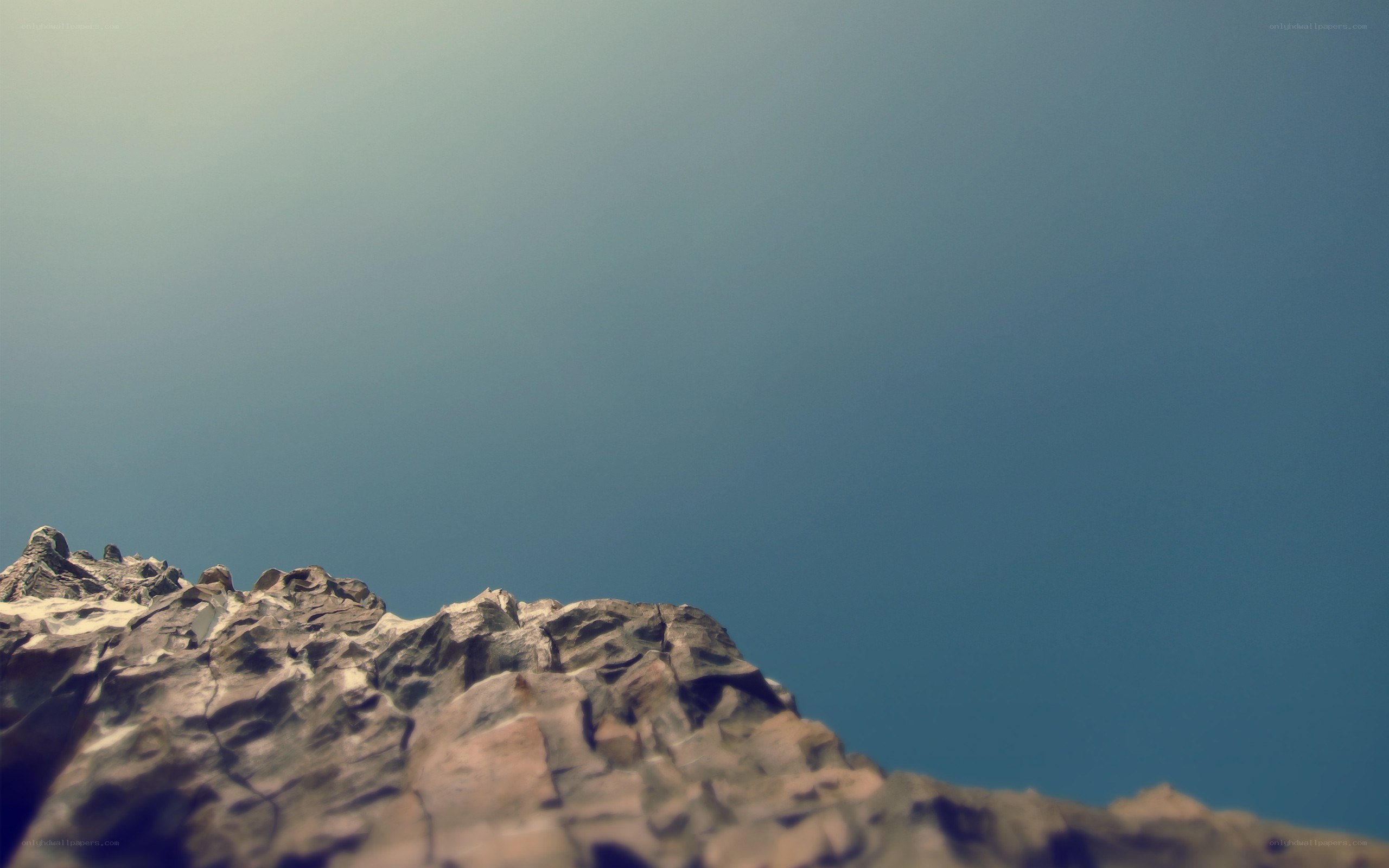 rocky cliff against blue sky