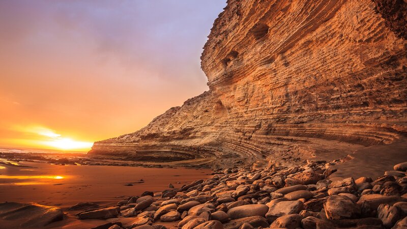 Rocky Cliff at Sunset — Orange, Dramatic, Photograph, Beach