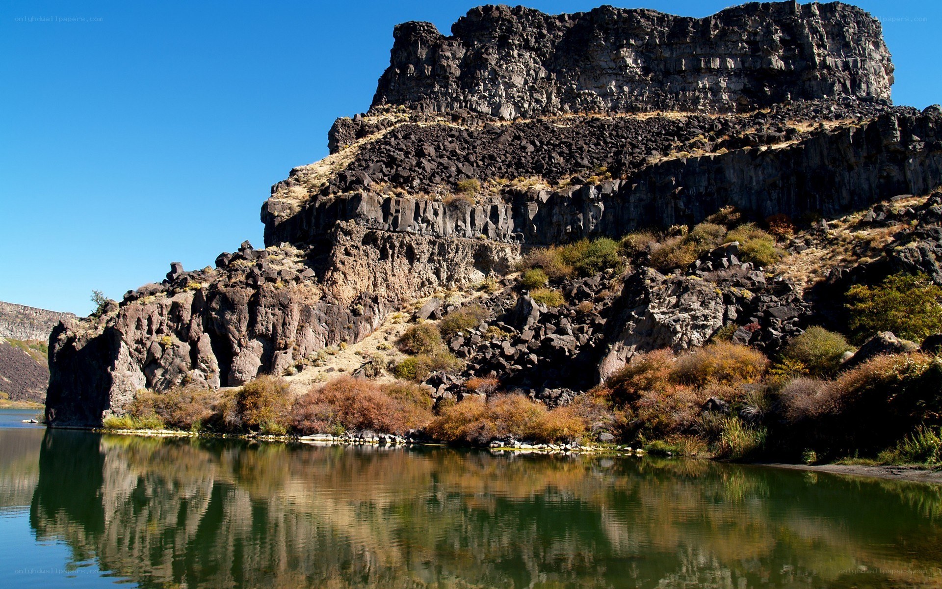 Rocky cliff by a calm river