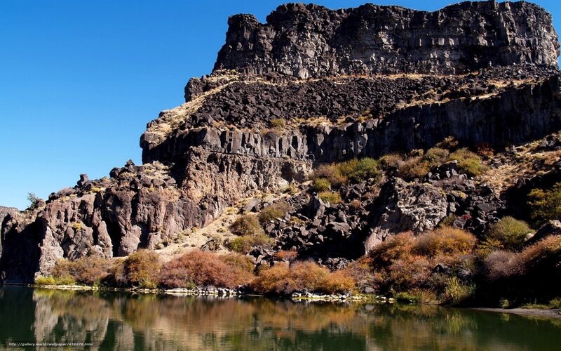 Rocky cliff by a calm river