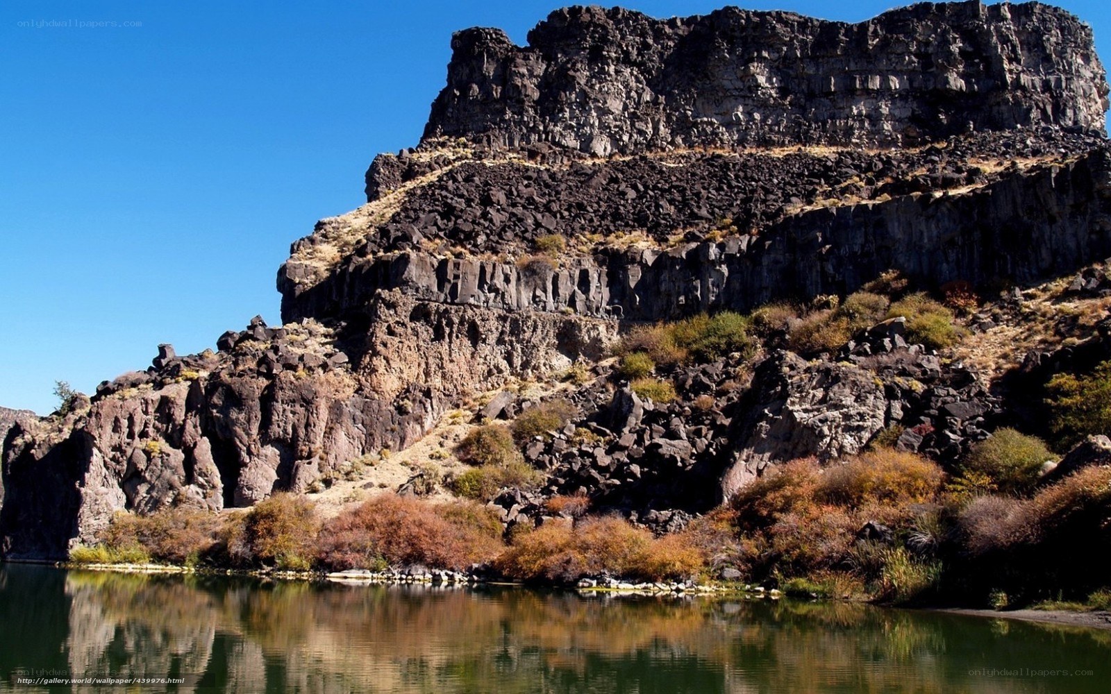 Rocky cliff by a calm river
