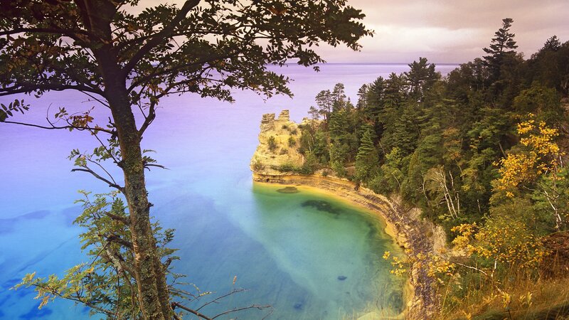 Rocky Cliff by Lake — Blue, Serene, Autumn, Photograph, Trees