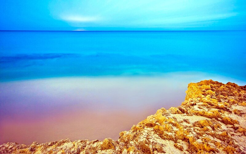 Rocky Cliff by Ocean — Blue