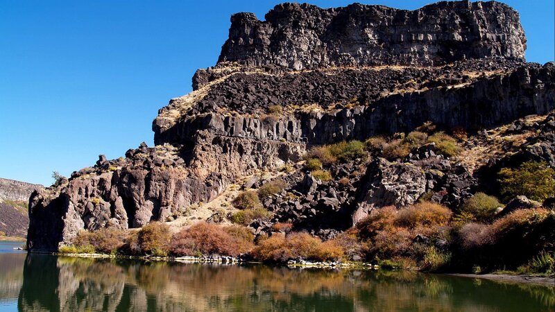Rocky Cliff by River — Blue