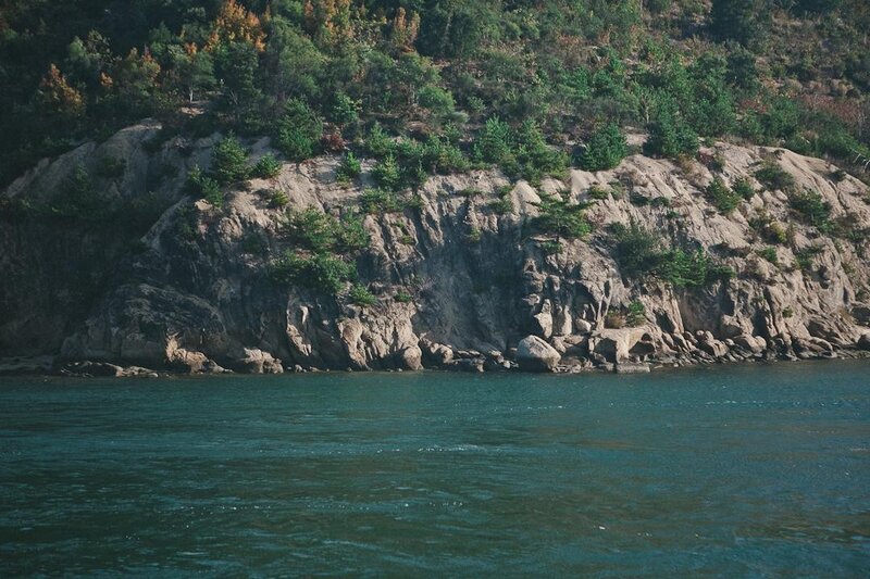 Rocky Cliff by Water — Green