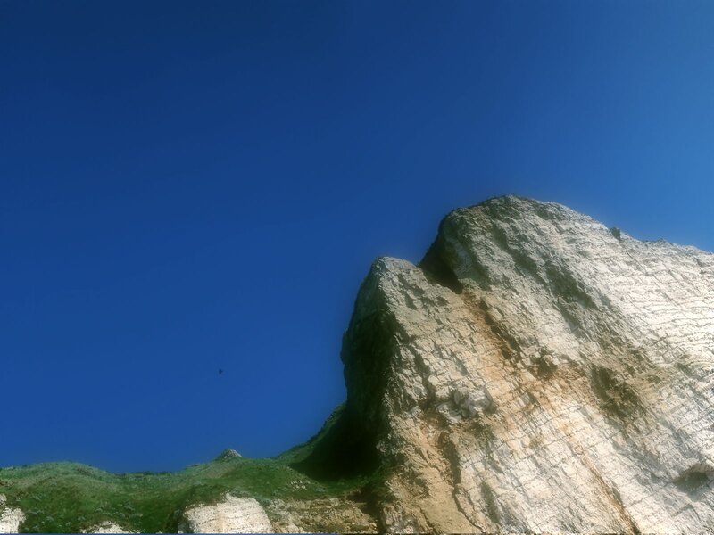 Rocky Cliff Face — Blue, Dramatic, Afternoon, Photograph, Sky