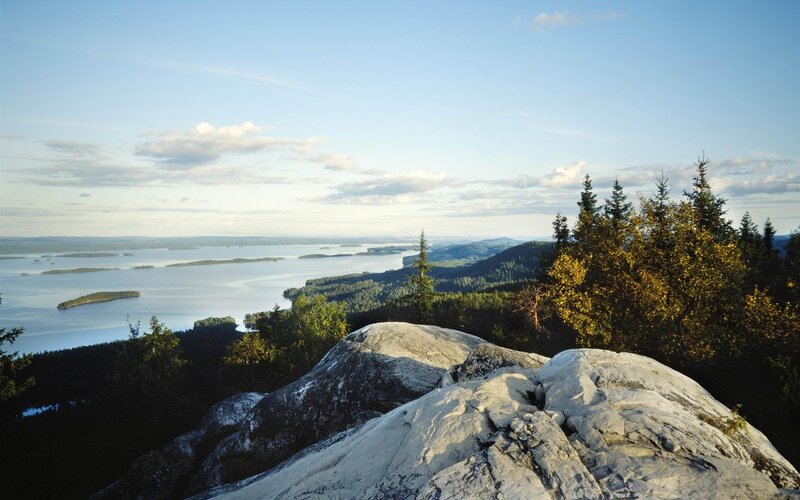 Rocky Cliff Overlooking Lake — Blue