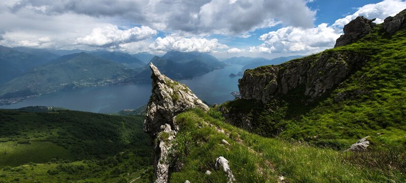 Rocky Cliff Overlooking Lake — Green, Serene, Afternoon